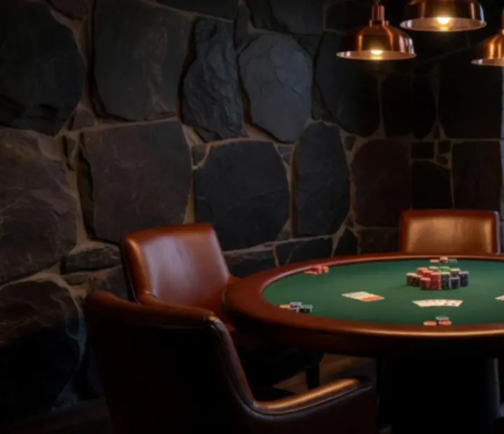 Leather chairs and poker table in the River Card Salon